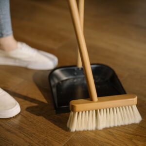 Closeup of a broom and dust pan