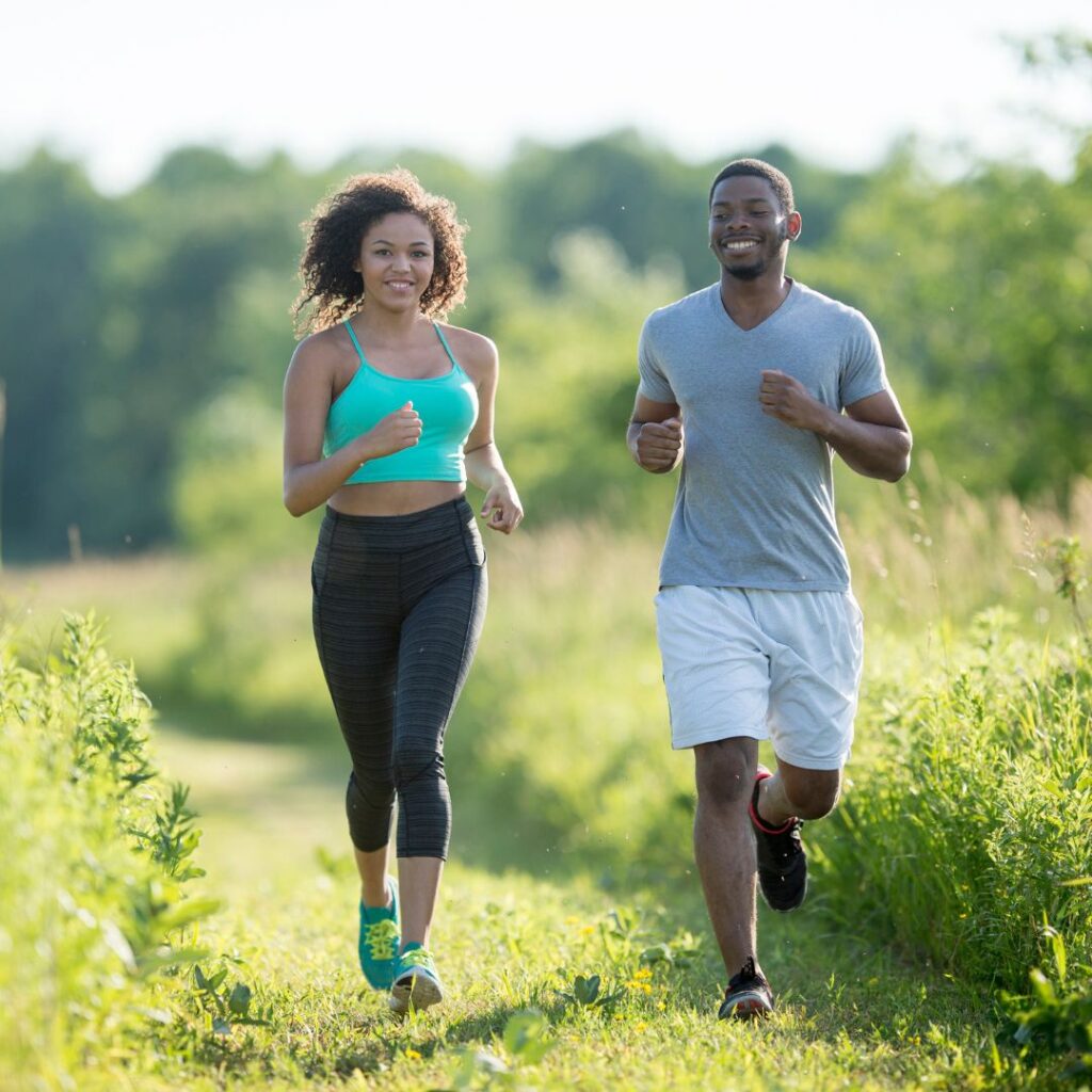 Two people running outside 
