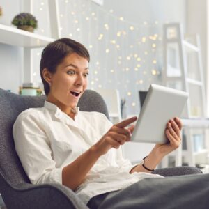 surprised woman looking at tablet