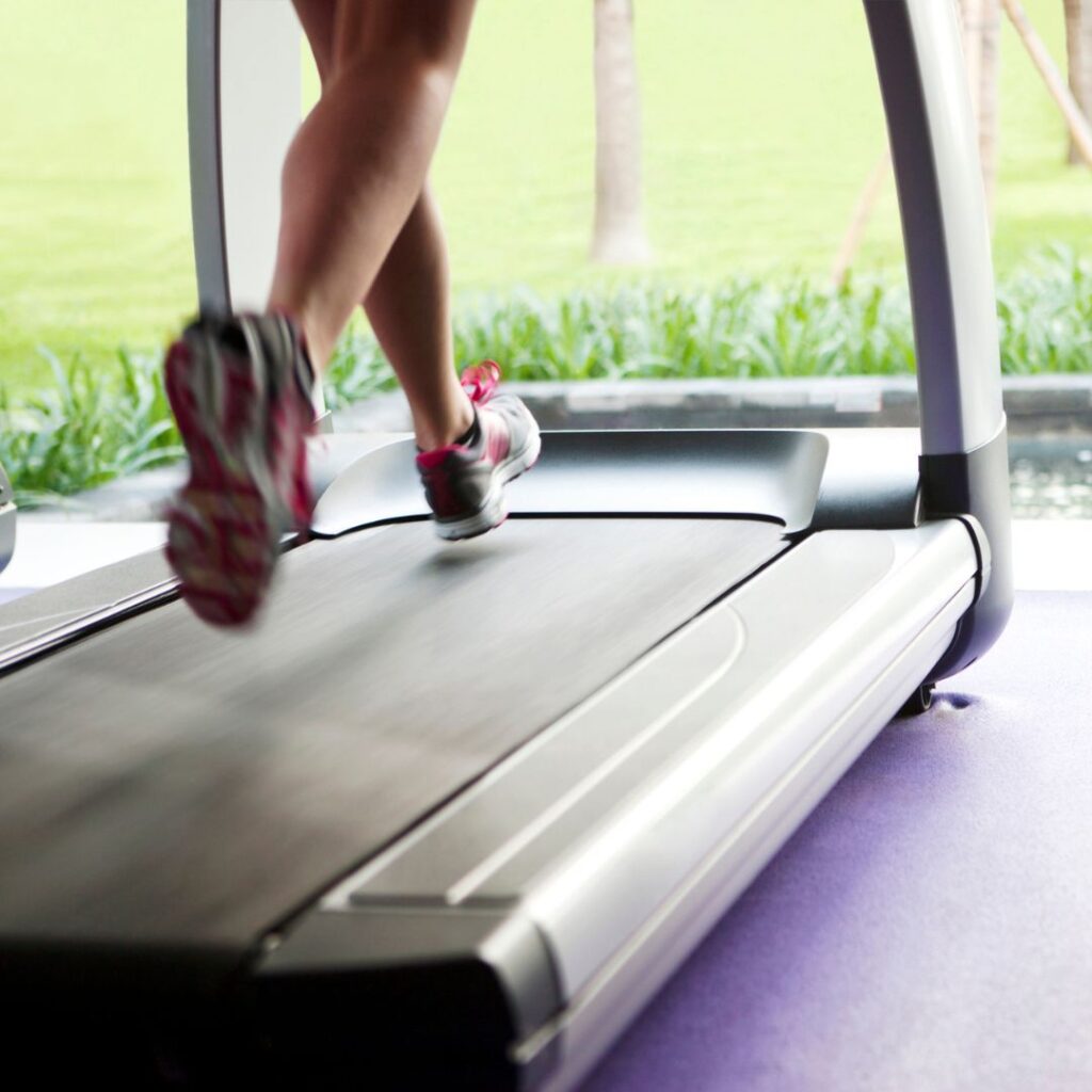 feet running on a treadmill