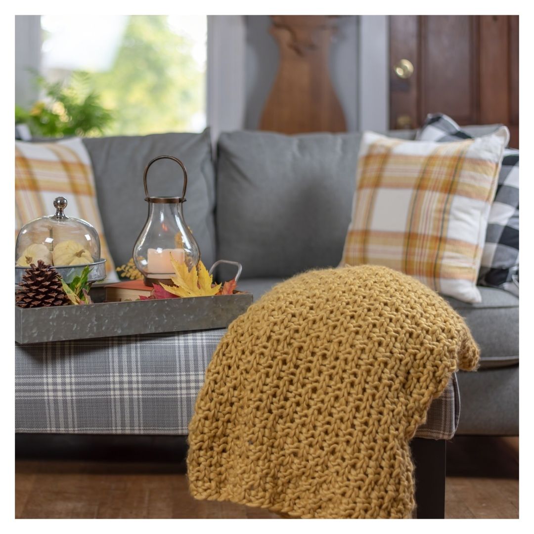fall colored pillows and blanket on a couch
