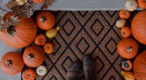 view of doormat decorated with pumpkins