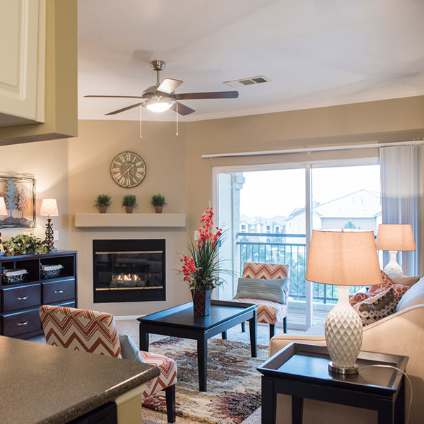 Stonegate apartment living room with fireplace and balcony