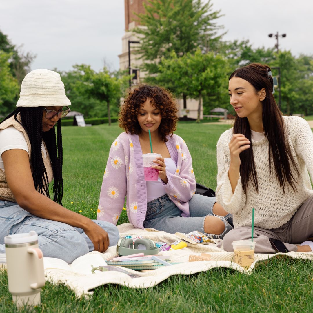 friends relaxing in a park near their apartment complex