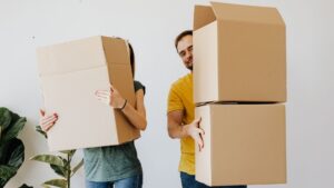 couple holding moving boxes